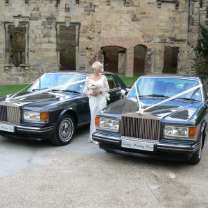 2 matching rolls-royce silver spirits with bride